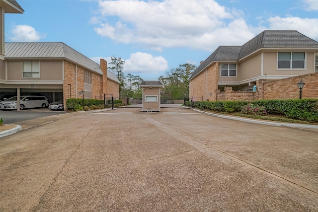 view of street with curbs and a gated entry