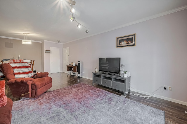 living area with baseboards, wood finished floors, track lighting, and ornamental molding