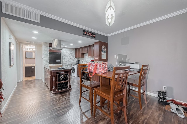 dining area with visible vents, dark wood-type flooring, ornamental molding, baseboards, and washer / dryer