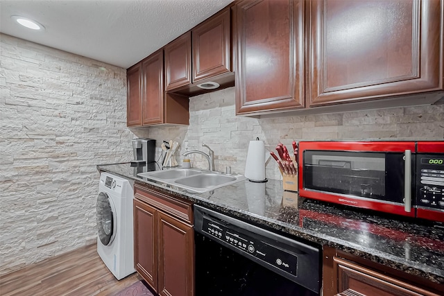 kitchen featuring washer / clothes dryer, a sink, light wood-style floors, dishwasher, and backsplash