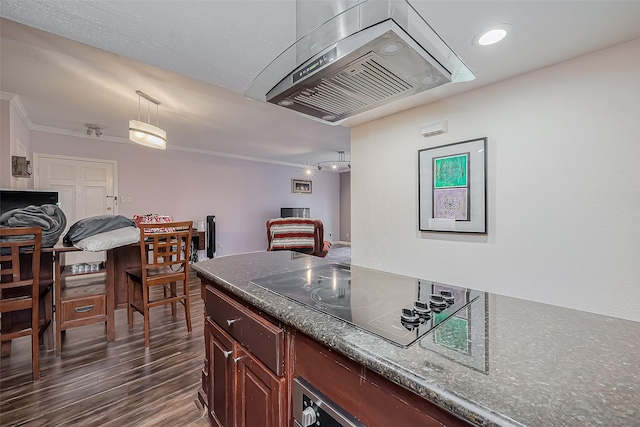 kitchen with dark countertops, dark wood finished floors, ventilation hood, crown molding, and black electric stovetop