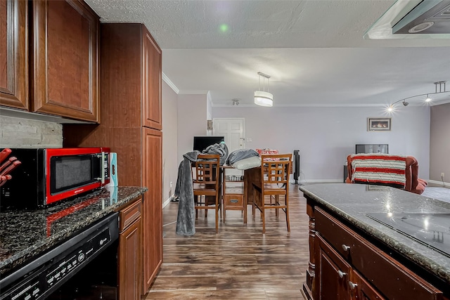 kitchen with baseboards, dark stone counters, dark wood-style flooring, black appliances, and crown molding