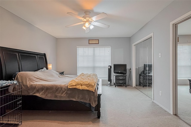 bedroom with ceiling fan, baseboards, a closet, and light carpet