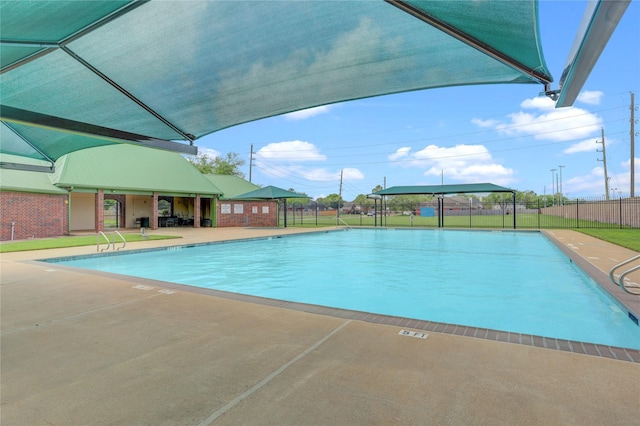 pool featuring fence and a patio