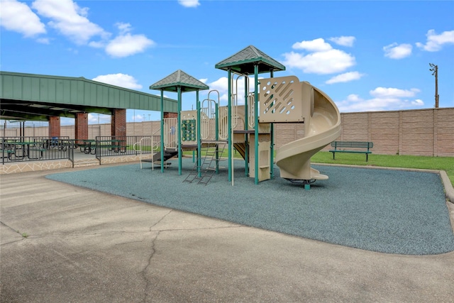 communal playground featuring fence
