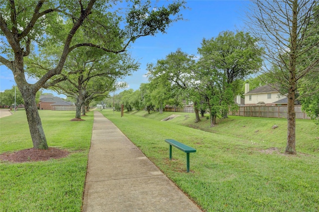 surrounding community with a yard and fence