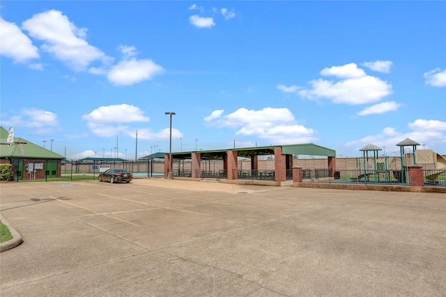 view of property with uncovered parking and fence