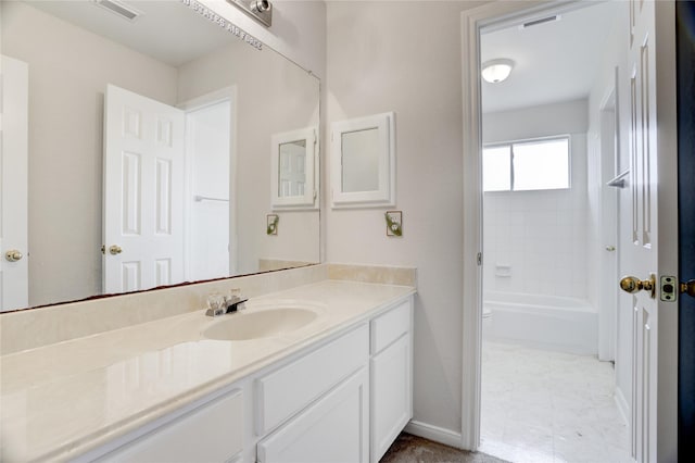 bathroom featuring baseboards, vanity, bathtub / shower combination, and visible vents