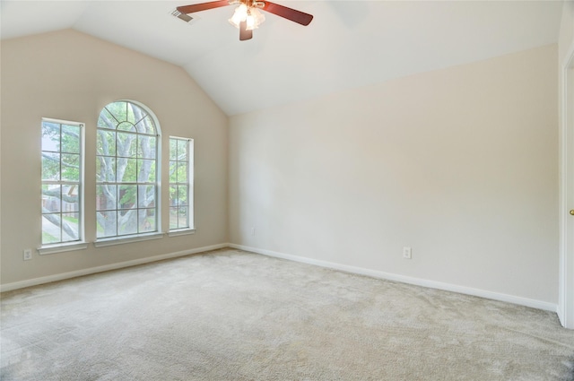 unfurnished room featuring lofted ceiling, carpet, visible vents, and a ceiling fan