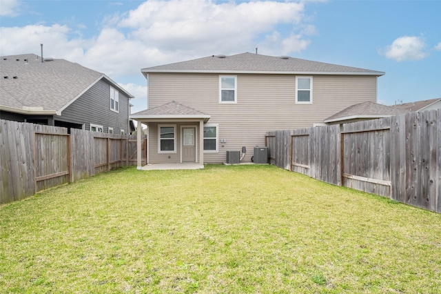 rear view of house with a patio, central air condition unit, a lawn, and a fenced backyard