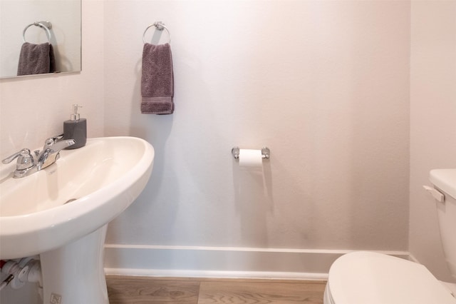 bathroom featuring toilet and a sink