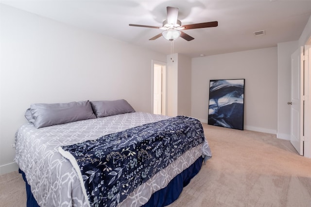 carpeted bedroom featuring baseboards, visible vents, and ceiling fan