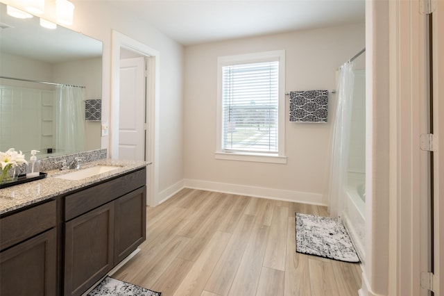 full bathroom featuring visible vents, vanity, baseboards, and wood finished floors