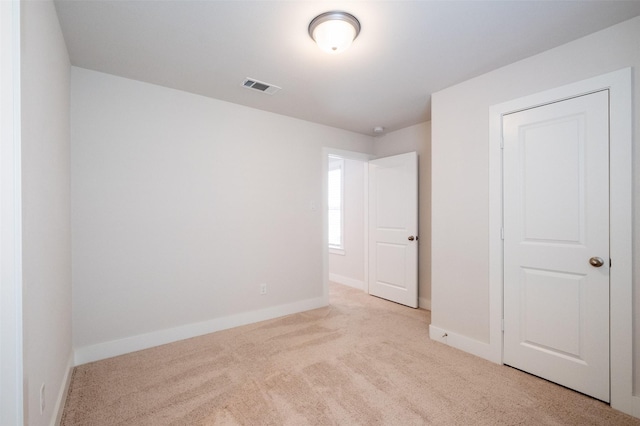 unfurnished bedroom featuring visible vents, baseboards, and carpet