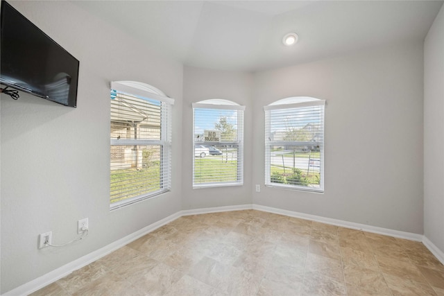 unfurnished room featuring baseboards