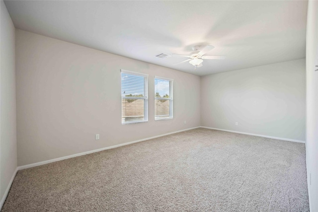 unfurnished room featuring a ceiling fan, visible vents, carpet floors, and baseboards