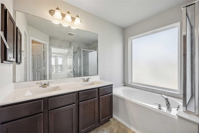 bathroom featuring a sink, visible vents, a garden tub, and a stall shower