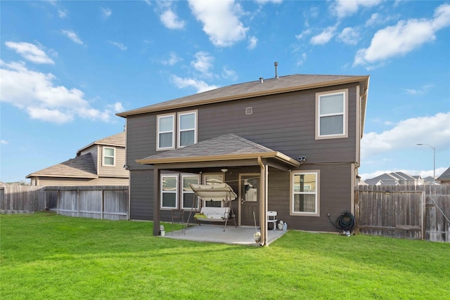 back of property with a patio area, a lawn, and a fenced backyard