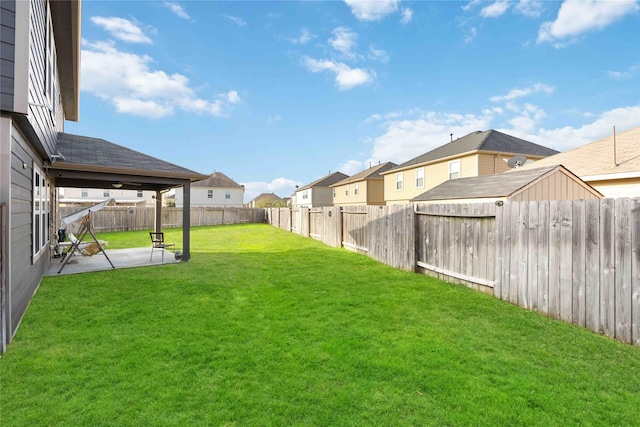 view of yard featuring a fenced backyard, a residential view, and a patio