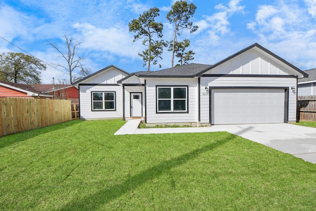 modern farmhouse with a front yard, fence, an attached garage, concrete driveway, and board and batten siding