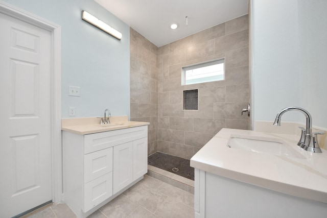 full bath with vanity and a tile shower