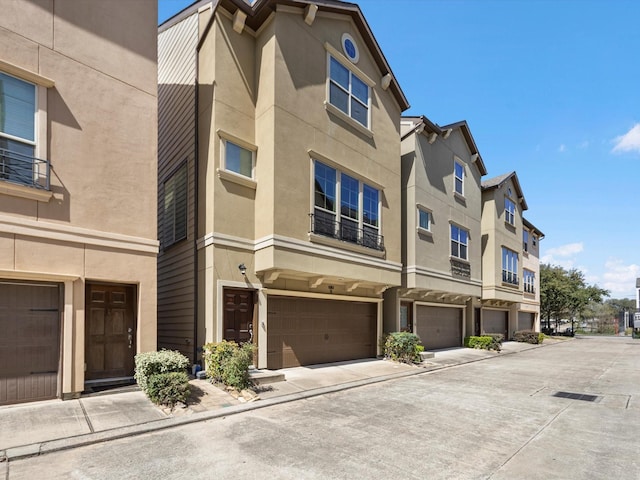 view of property with an attached garage and a residential view