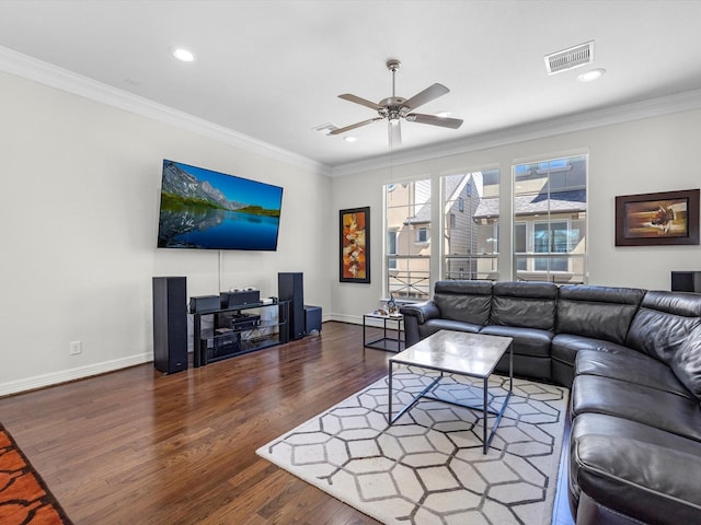 living area featuring visible vents, wood finished floors, and ornamental molding