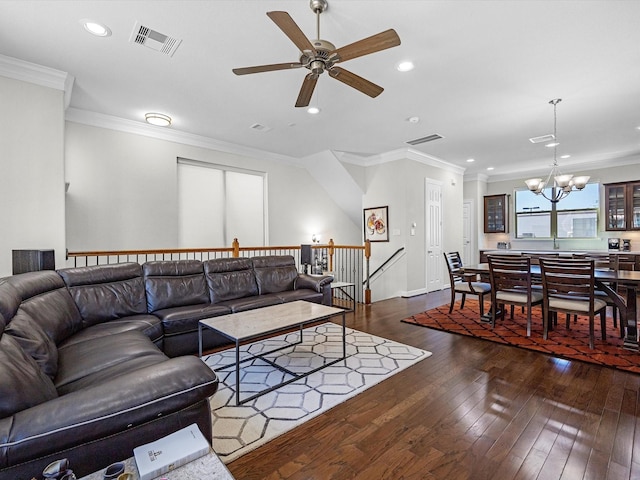 living room with visible vents, recessed lighting, ornamental molding, wood-type flooring, and ceiling fan with notable chandelier