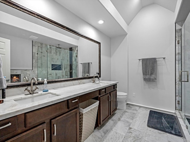 bathroom with a sink, marble finish floor, a shower stall, and vaulted ceiling