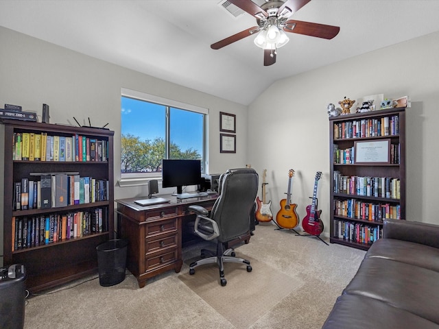 carpeted home office with visible vents, ceiling fan, and vaulted ceiling