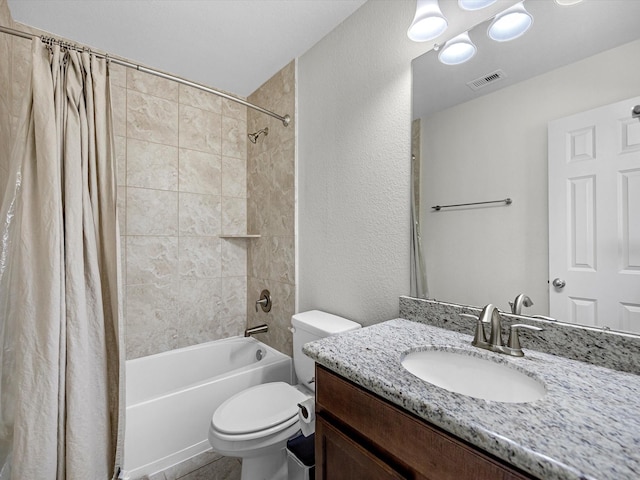 full bath featuring visible vents, shower / bath combo with shower curtain, toilet, vanity, and a textured wall