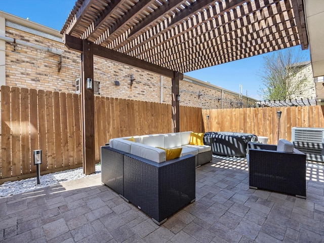 view of patio / terrace with an outdoor living space, a pergola, and a fenced backyard