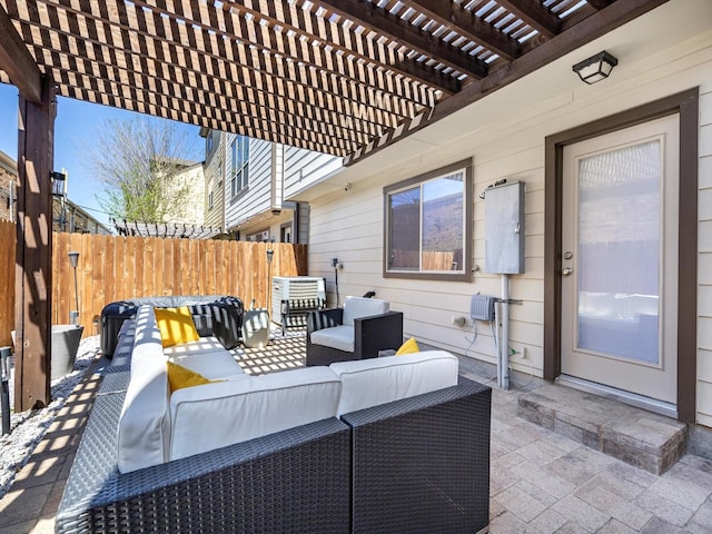 view of patio / terrace featuring an outdoor hangout area, a pergola, and fence