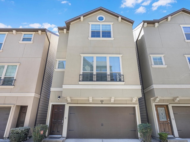 view of property with an attached garage and stucco siding