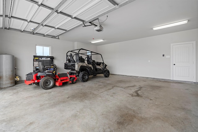 garage with gas water heater and a garage door opener