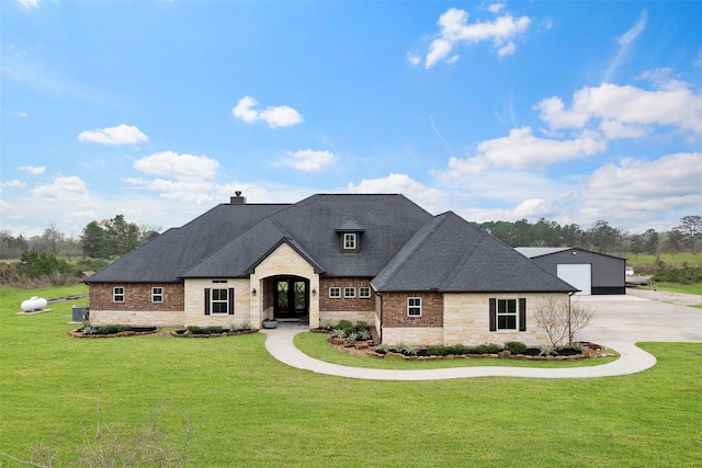 french country inspired facade featuring a front lawn, french doors, a chimney, and a shingled roof