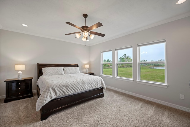 carpeted bedroom featuring recessed lighting, baseboards, ornamental molding, and a ceiling fan