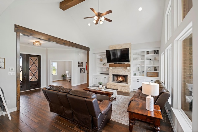 living room with baseboards, ceiling fan, beam ceiling, a fireplace, and dark wood-style floors