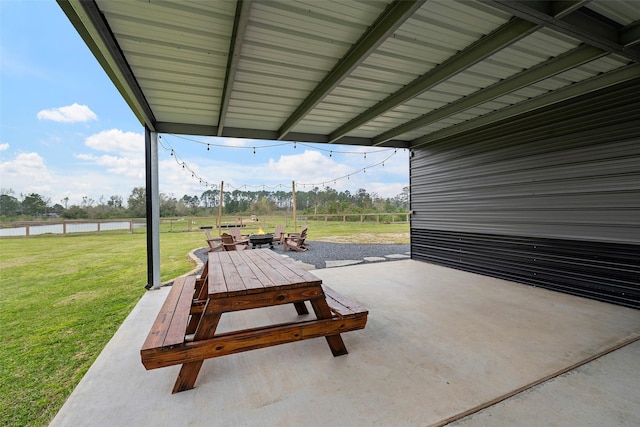 view of patio featuring a fire pit and a water view