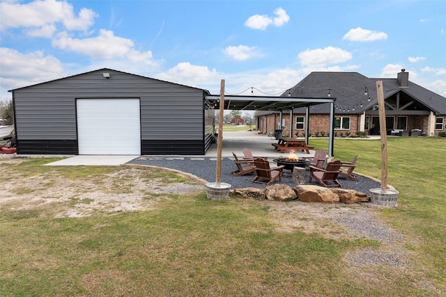 view of yard featuring an outbuilding and an outdoor fire pit