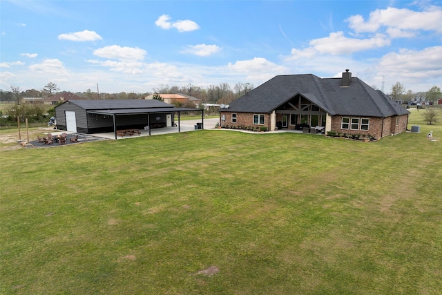 view of yard featuring a detached carport and an outdoor structure