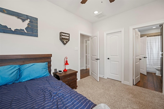 bedroom featuring visible vents, ensuite bathroom, carpet floors, baseboards, and ceiling fan