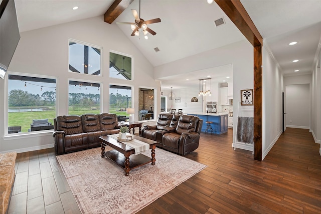 living room with beamed ceiling, visible vents, dark wood-type flooring, high vaulted ceiling, and ceiling fan with notable chandelier