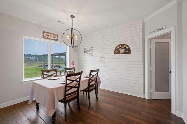 dining room with visible vents, ornamental molding, dark wood finished floors, an inviting chandelier, and baseboards