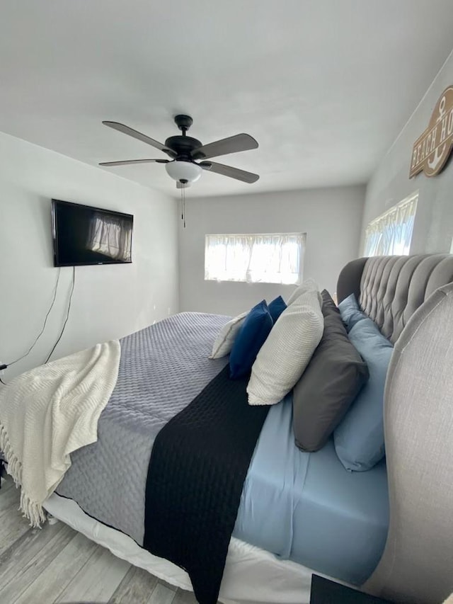 bedroom with ceiling fan and wood finished floors