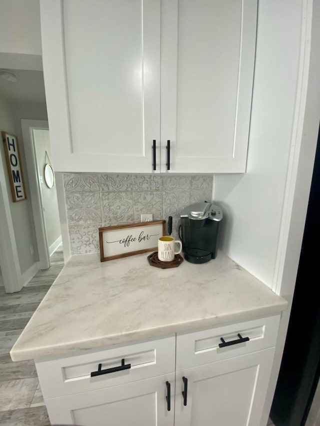 interior details with decorative backsplash and baseboards