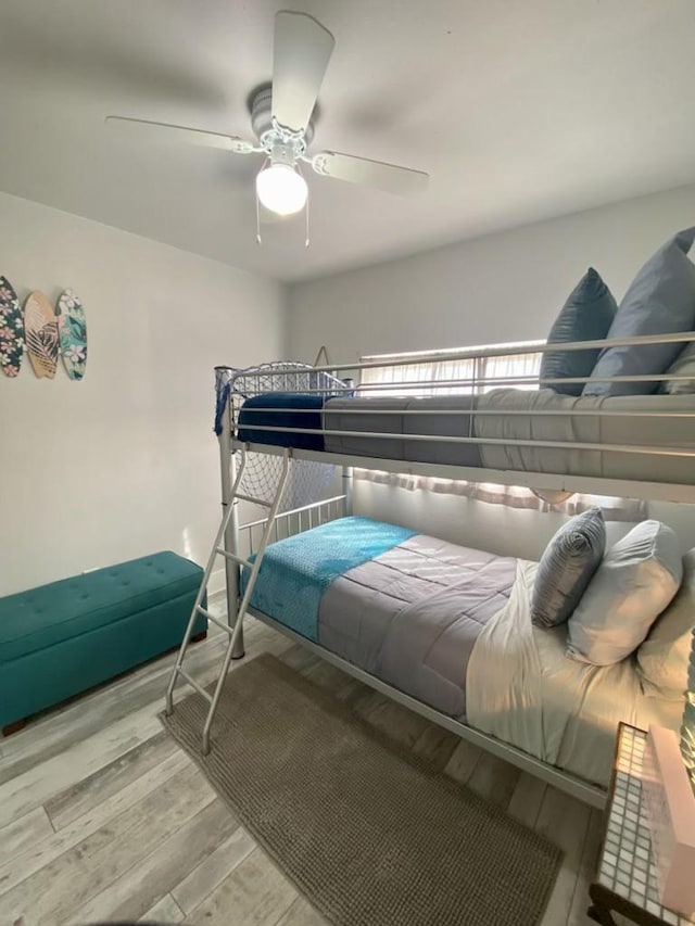 bedroom with a ceiling fan and wood finished floors