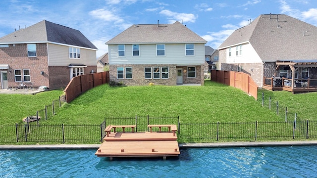 back of property with a lawn and a fenced backyard