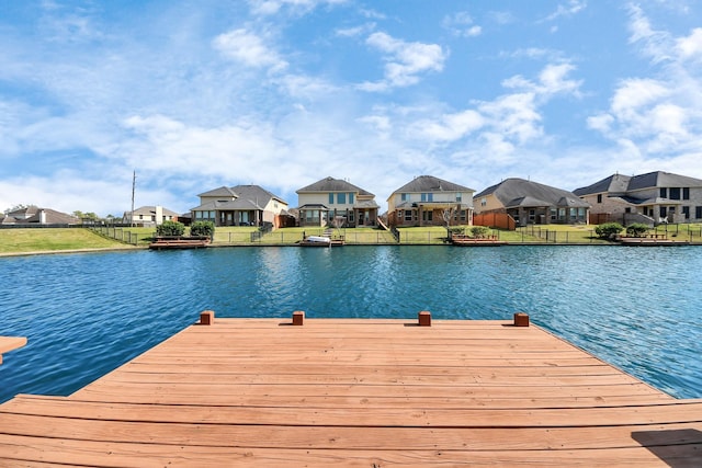 dock area featuring a residential view and a water view