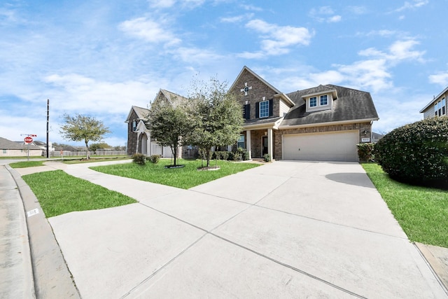 view of front facade featuring brick siding, a garage, concrete driveway, and a front lawn